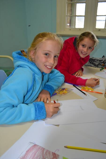 Bella Humm, 10, and Cate Devereux, 10, work on lighthouse drawings.