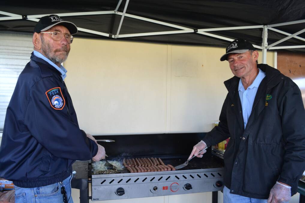 AT THE BARBIE: Mal Johnson and Paul Byers of the Augusta Sea Search and Rescue man the barbecue.